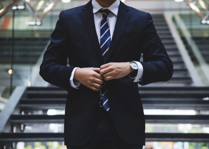 Man Buttoning Up Suit Jacket 1