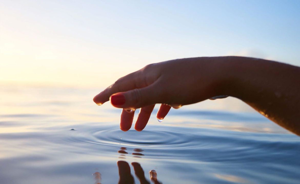 Hand Touching Water