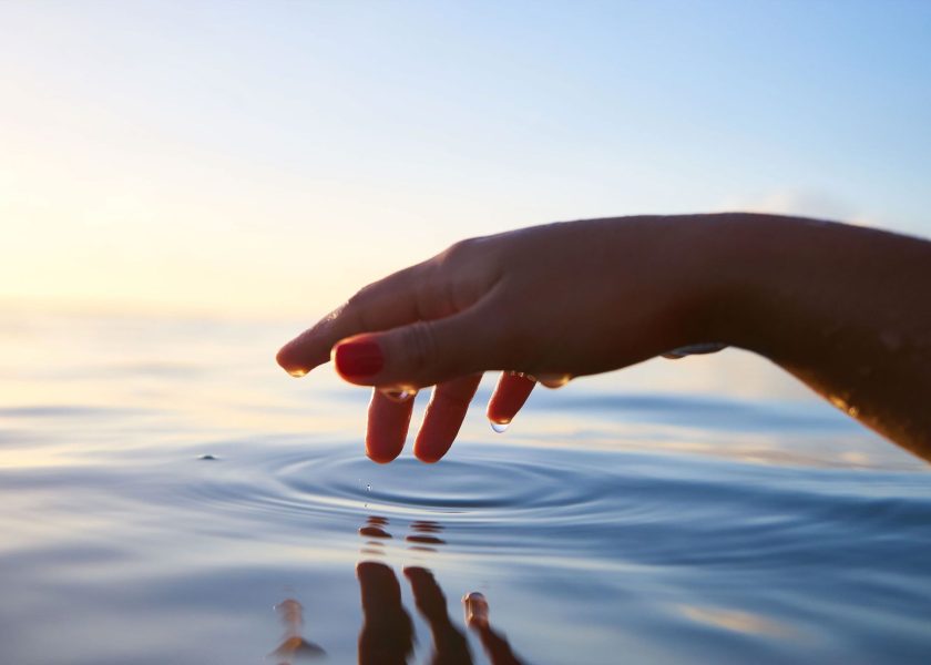 Hand Touching Water