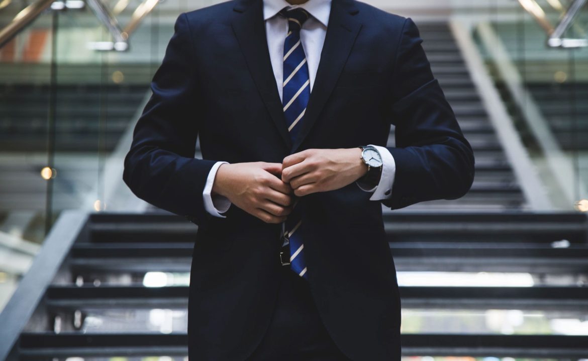 Man Buttoning Up Suit Jacket