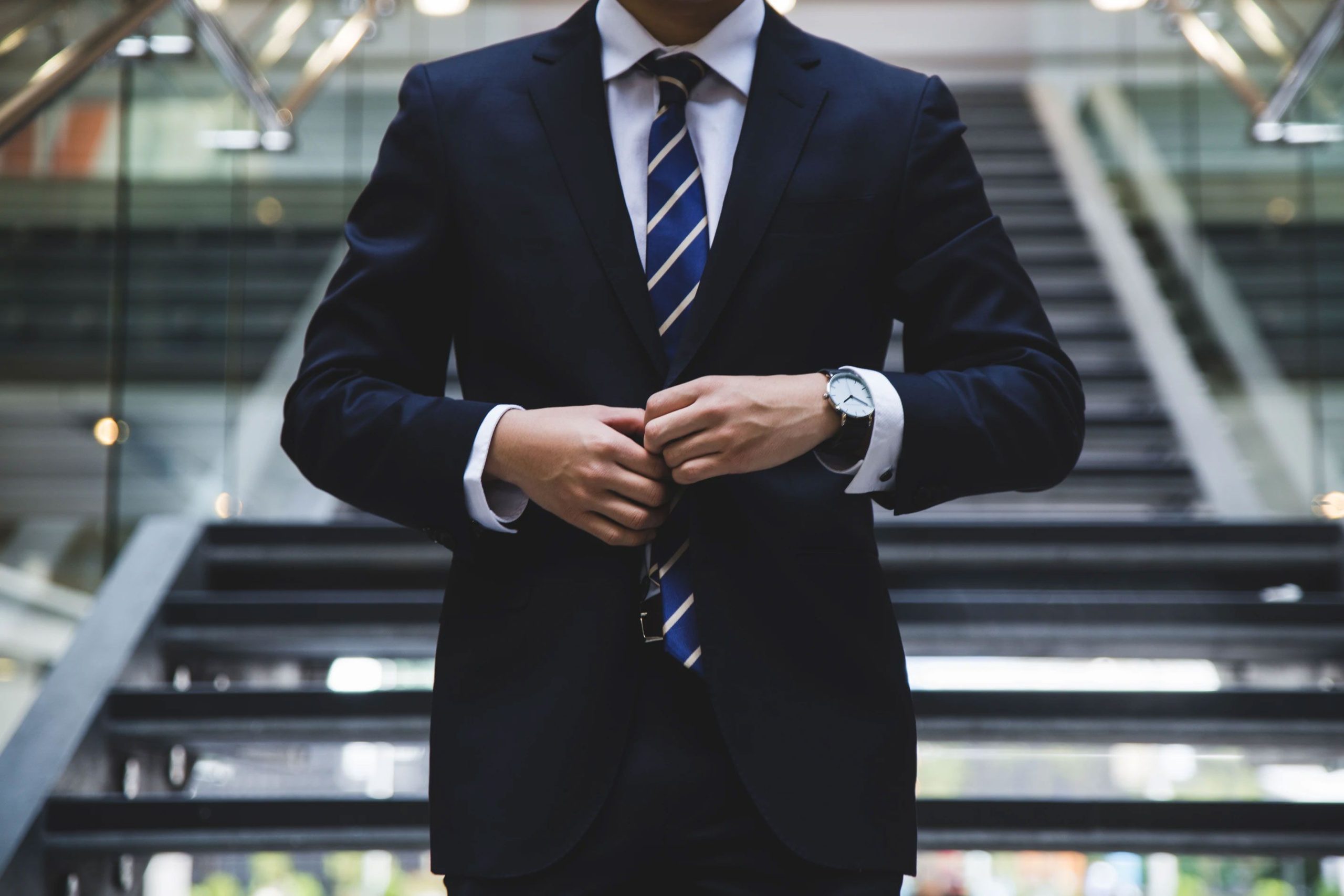 Man Buttoning Up Suit Jacket