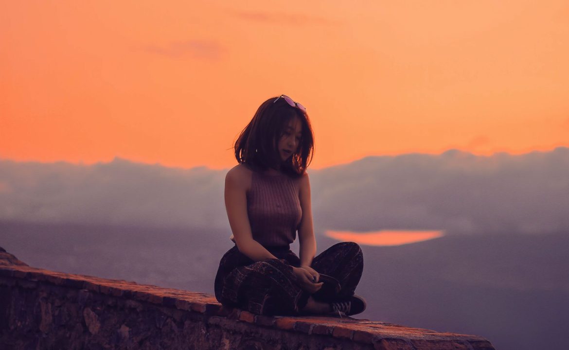 Woman sitting on a Wall