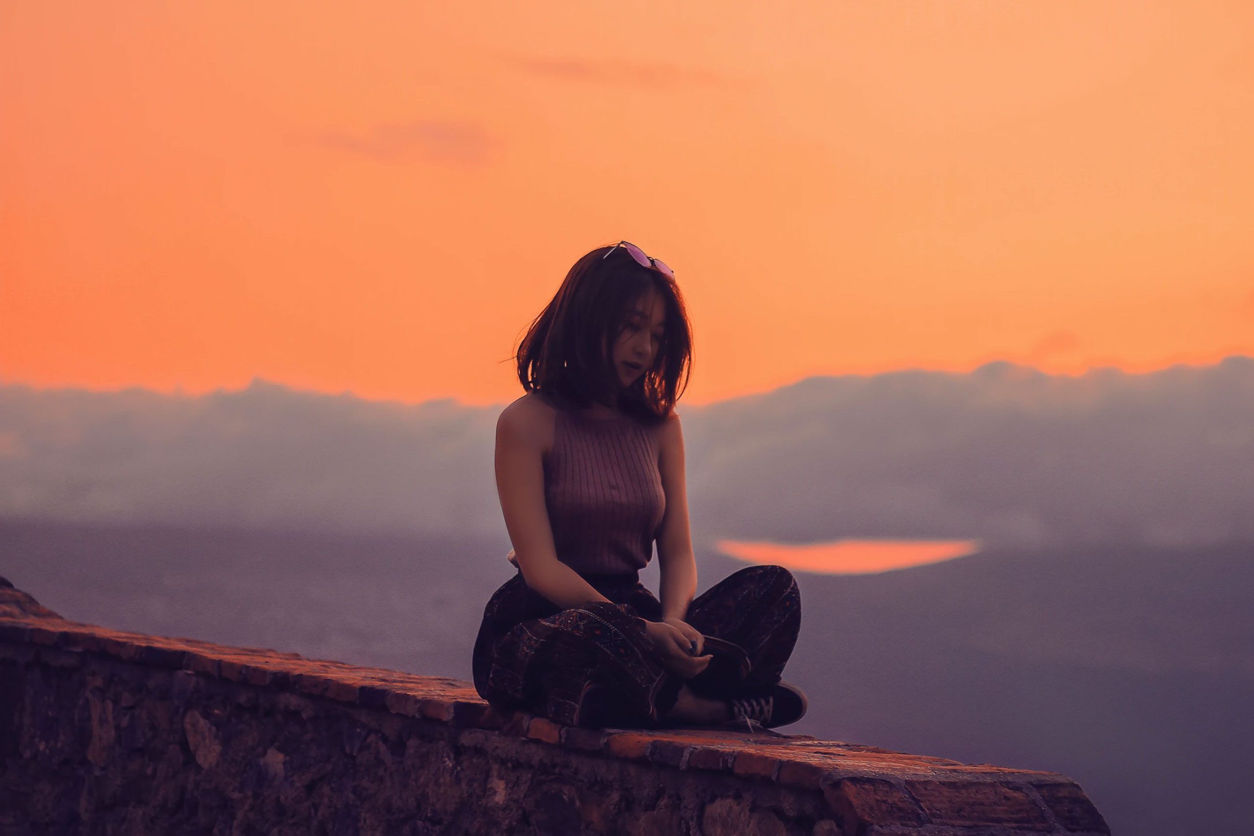 Woman sitting on a Wall