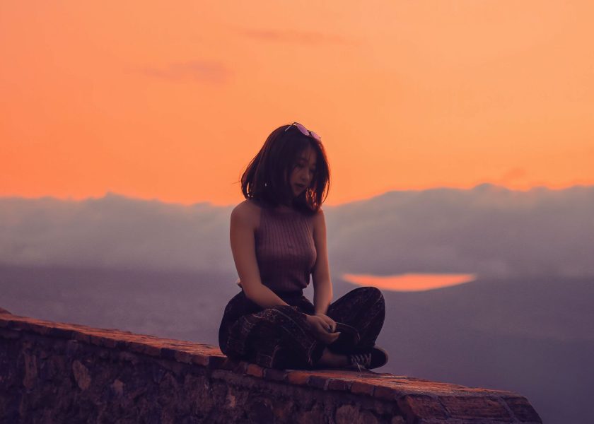 Woman sitting on a Wall