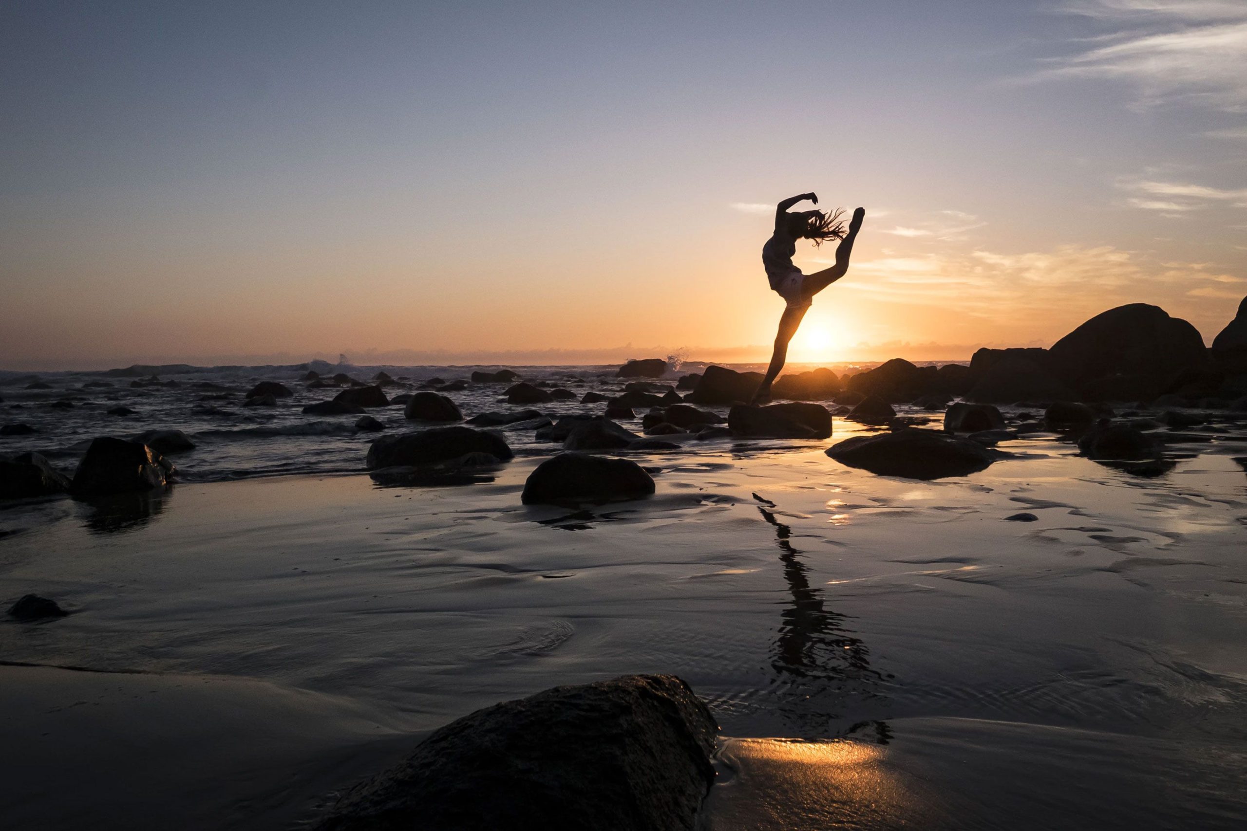 Woman doing Yoga at the Beach