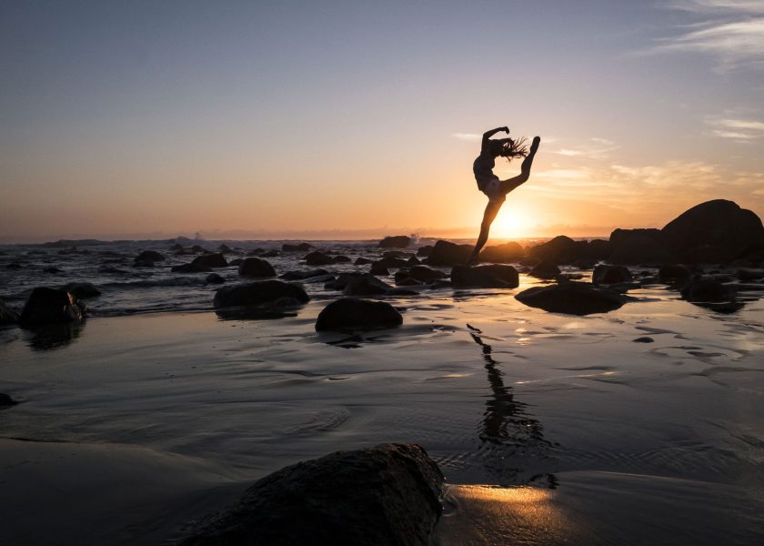 Woman doing Yoga at the Beach